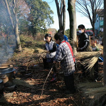 藁でご飯を炊いている様子